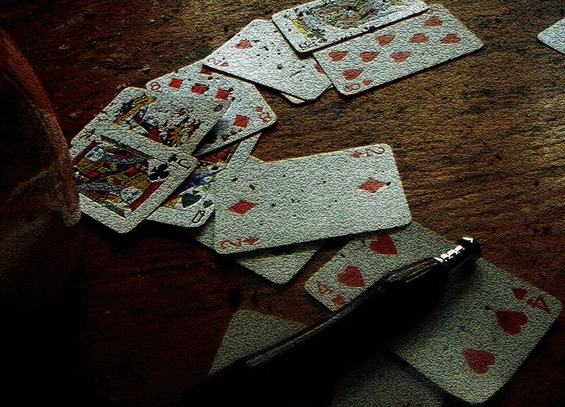 scattered playing cards on table