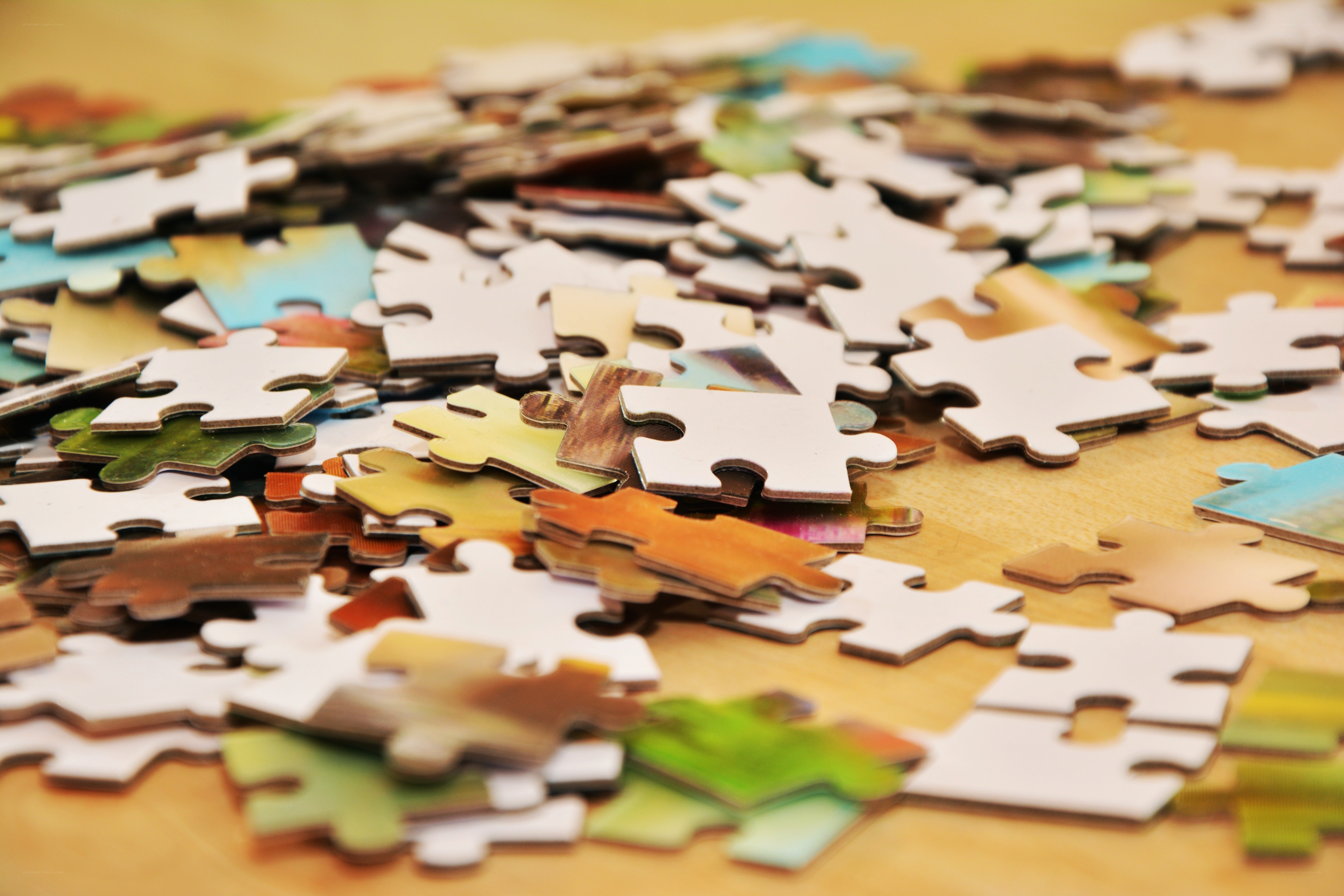 Scattered puzzle pieces on table