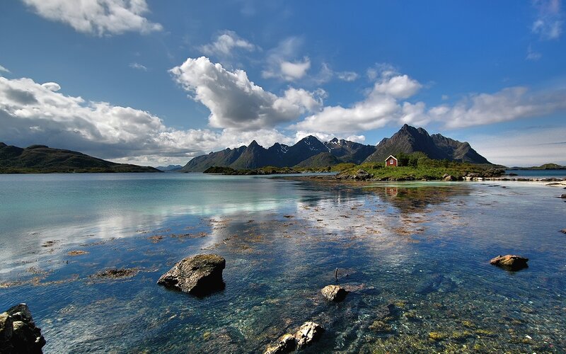 Scenic fjord with red cabin