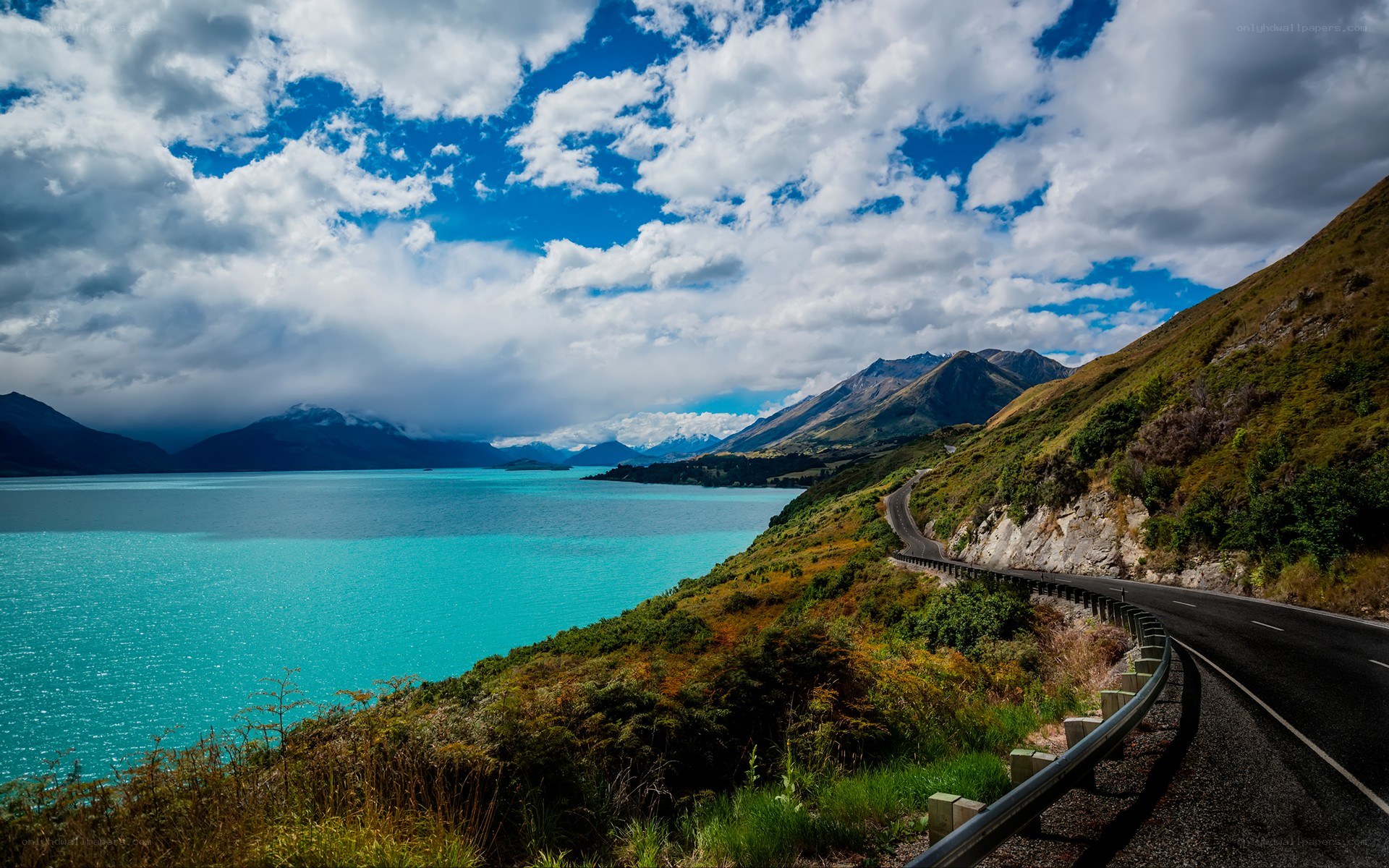 Scenic road along turquoise lake