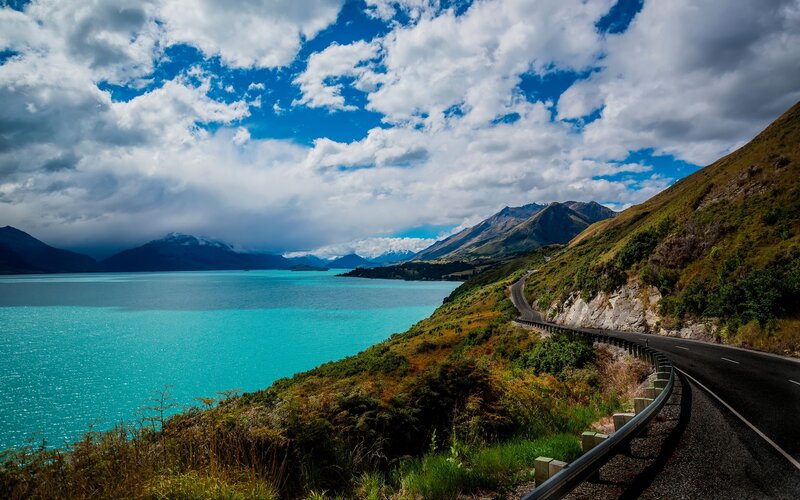 Scenic road along turquoise lake