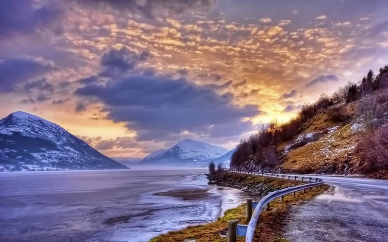 Scenic road by frozen fjord