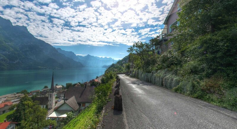 Scenic road by lake and mountains