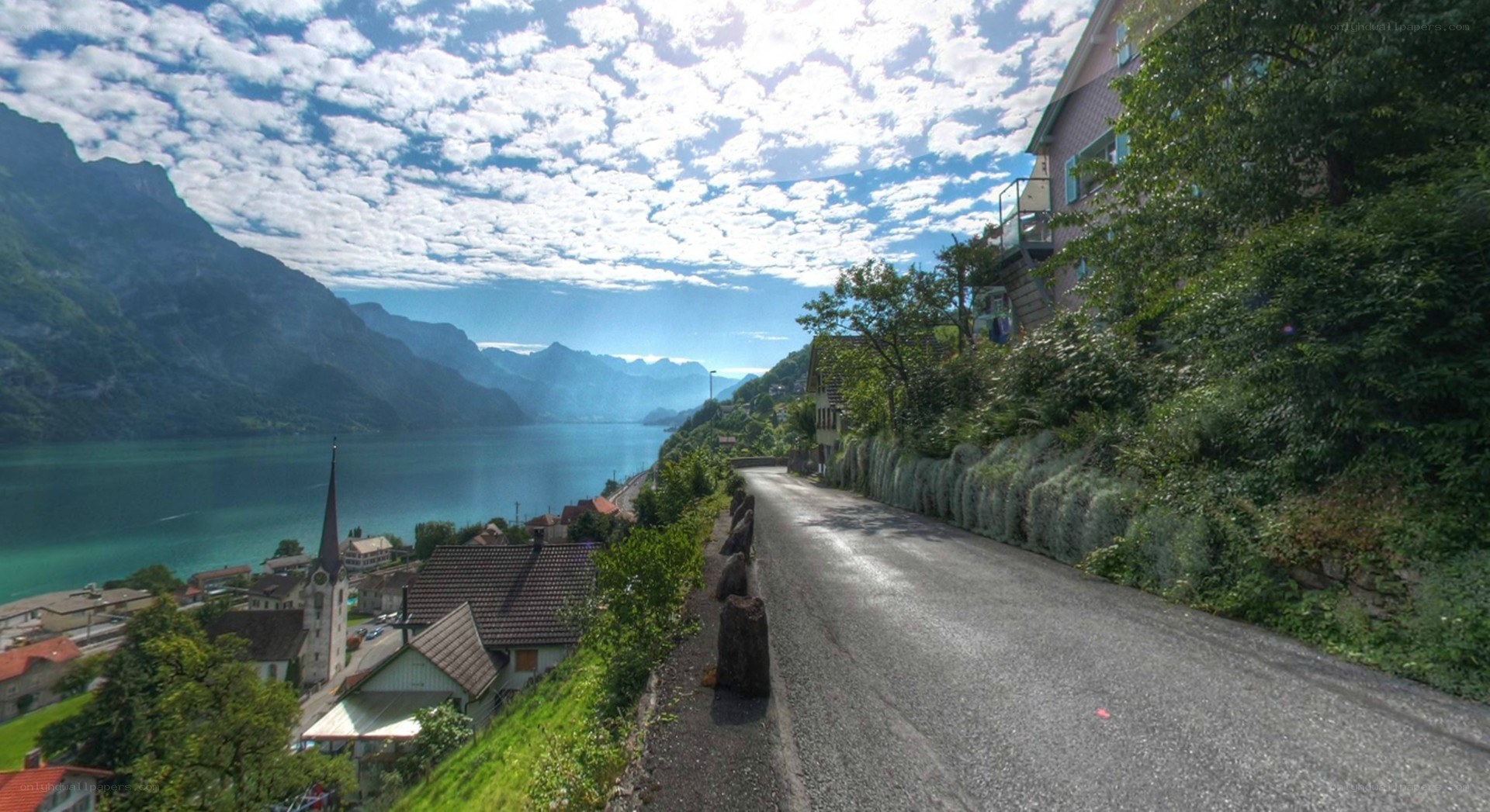 Scenic road by lake and mountains
