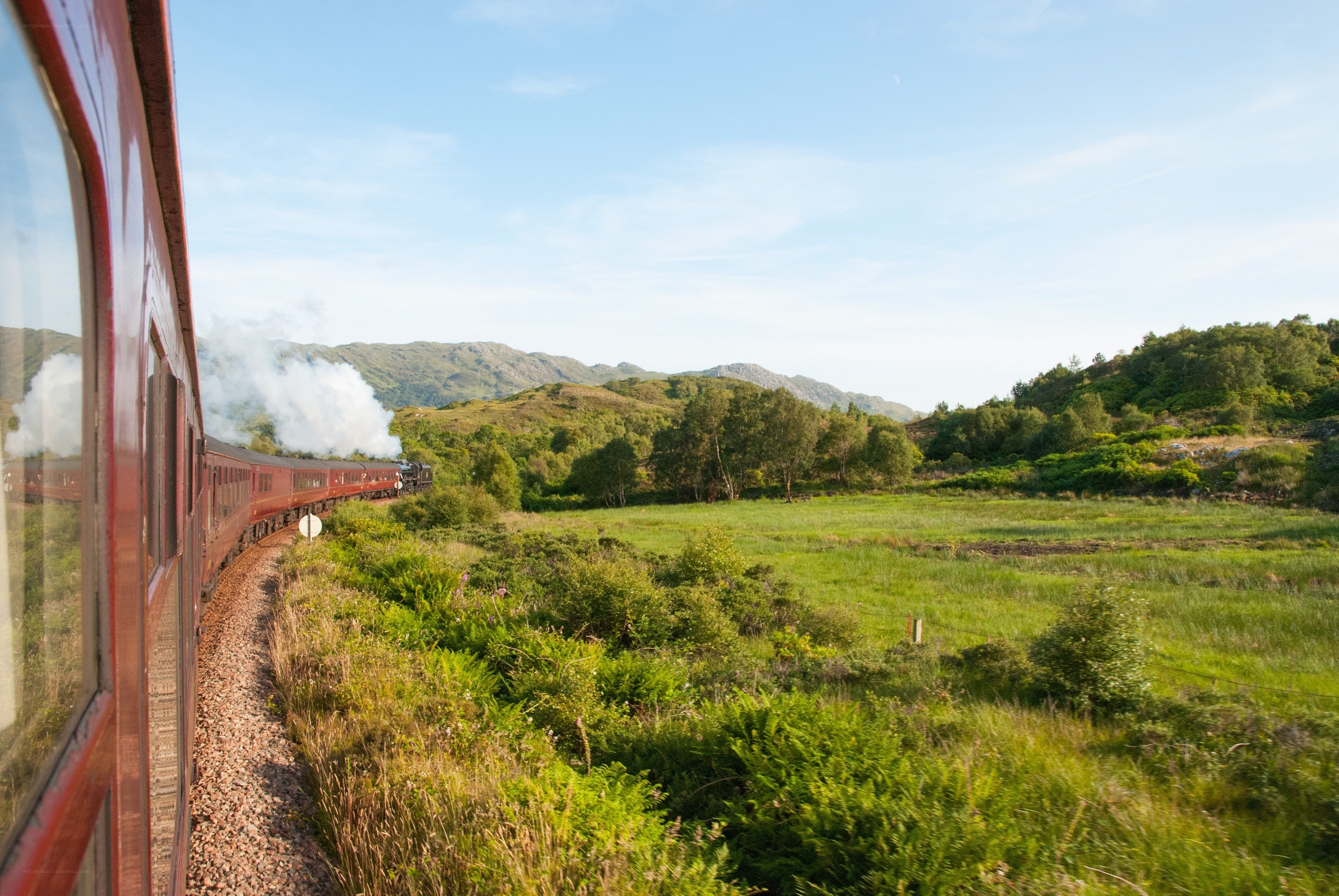 Scenic train journey through green hills