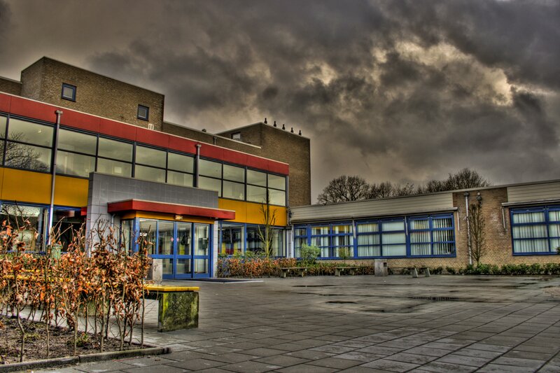 School building under stormy sky