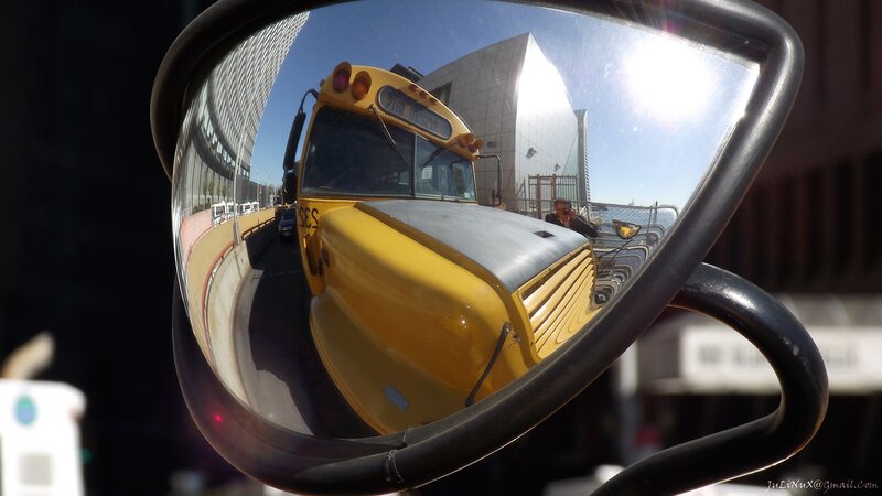 School bus reflected in side mirror