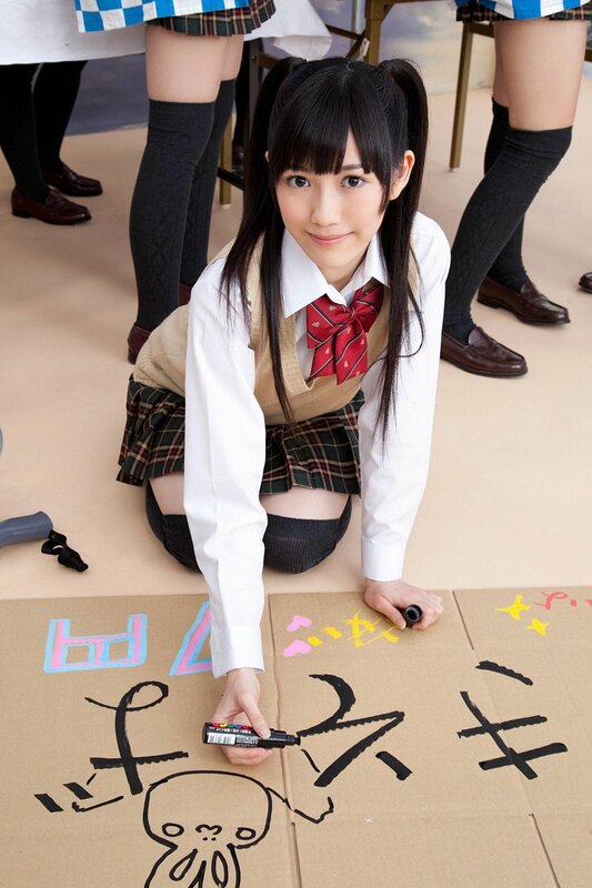 Schoolgirl drawing on cardboard