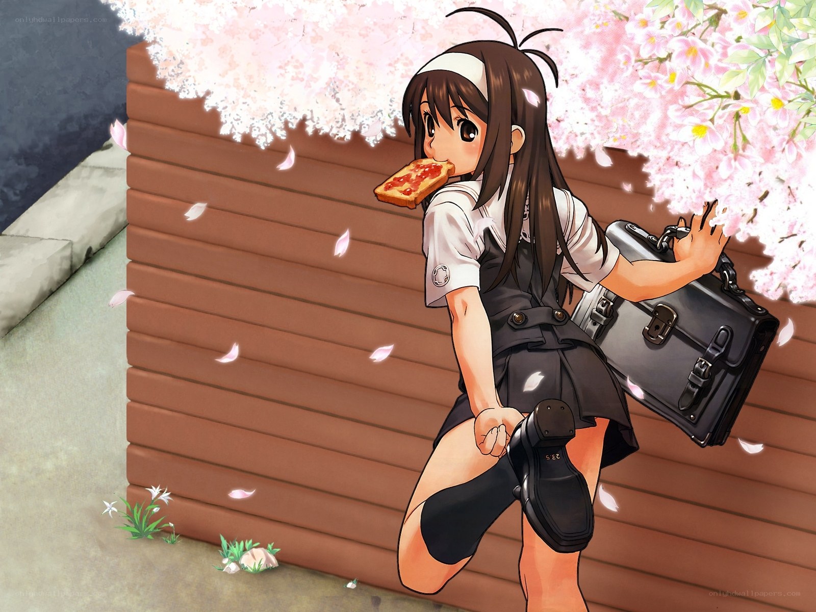 Schoolgirl eating toast under cherry blossoms