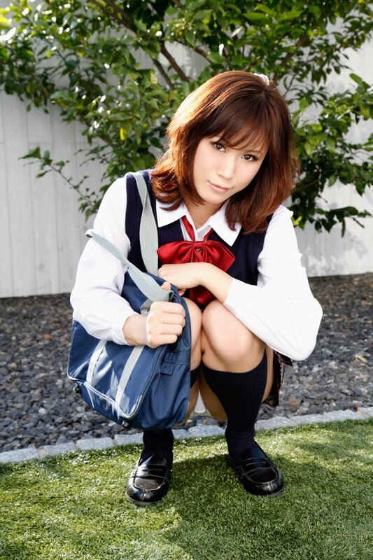 schoolgirl in uniform crouching