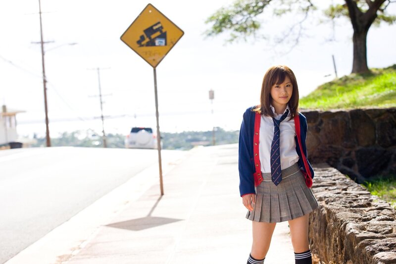 schoolgirl on a sunny sidewalk