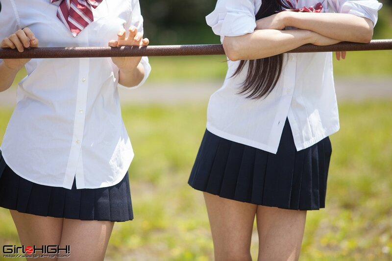 schoolgirls at a fence