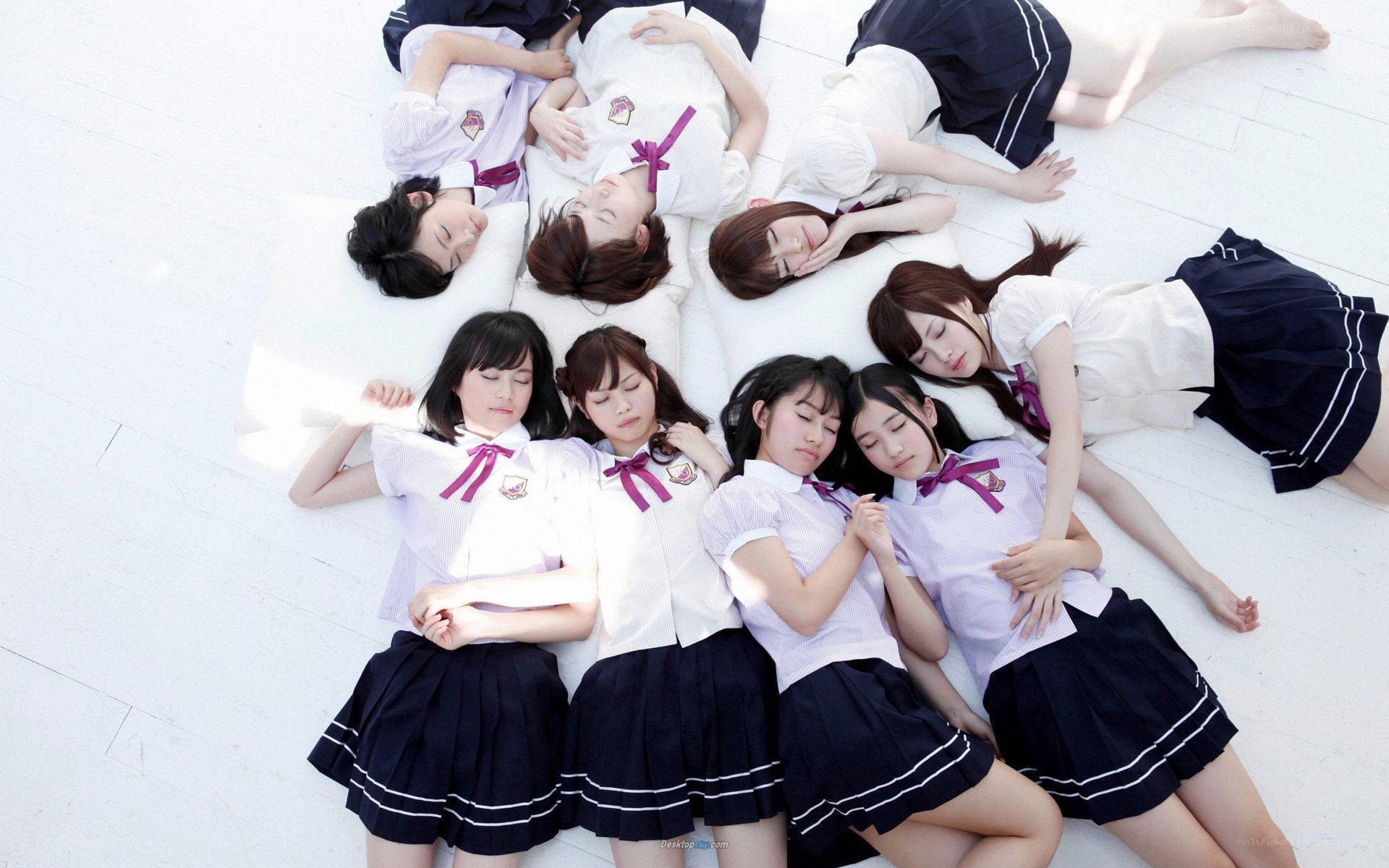 schoolgirls in uniform lying down