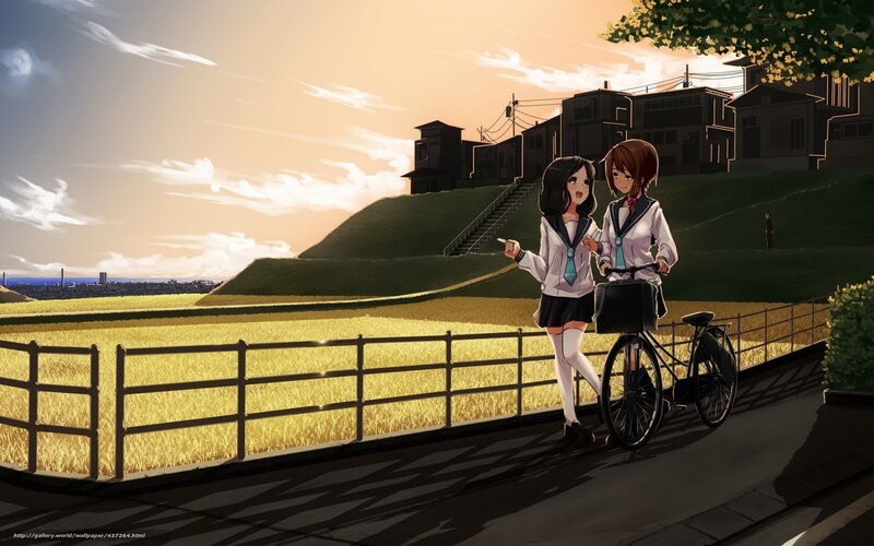 Schoolgirls on a bike at sunset