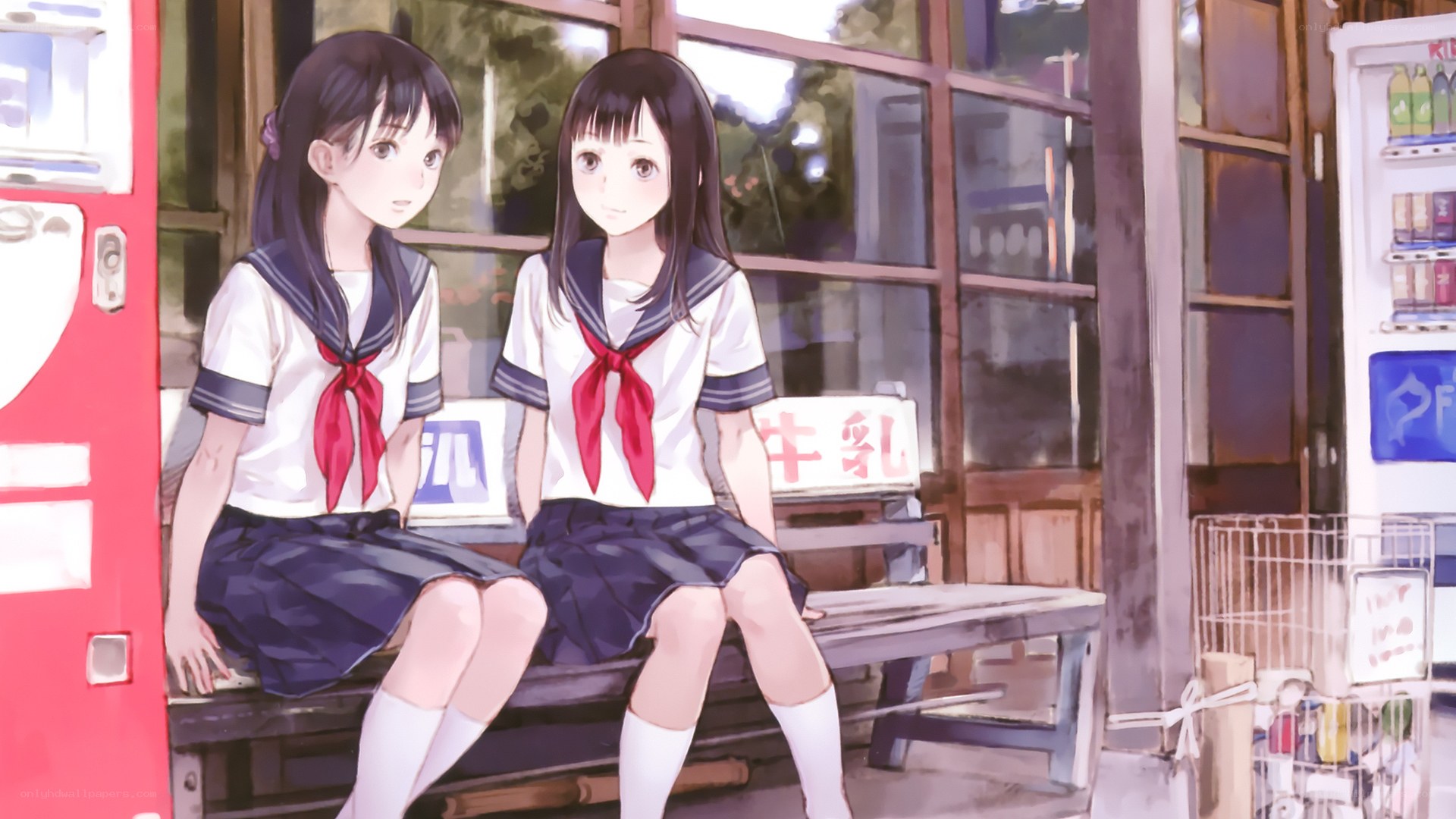 schoolgirls sitting on a bench
