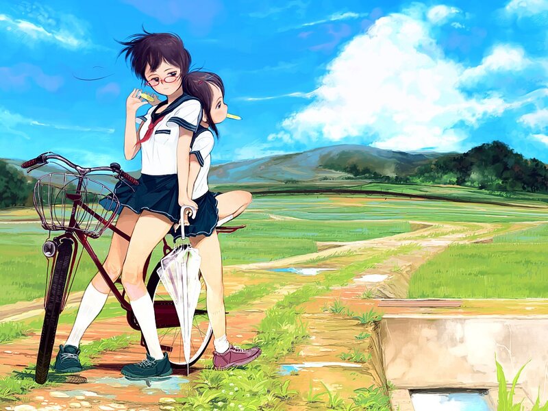 Schoolgirls with bicycle in field