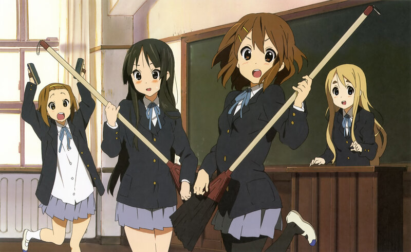 Schoolgirls with brooms in classroom