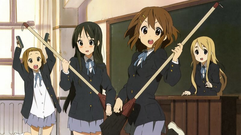 Schoolgirls with brooms in classroom