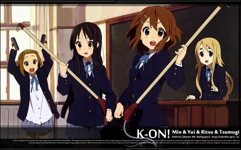 Schoolgirls with brooms in classroom