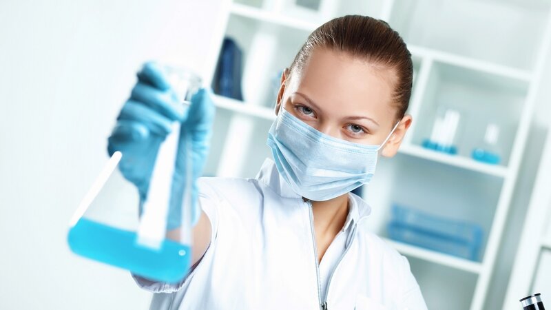 scientist holding beaker