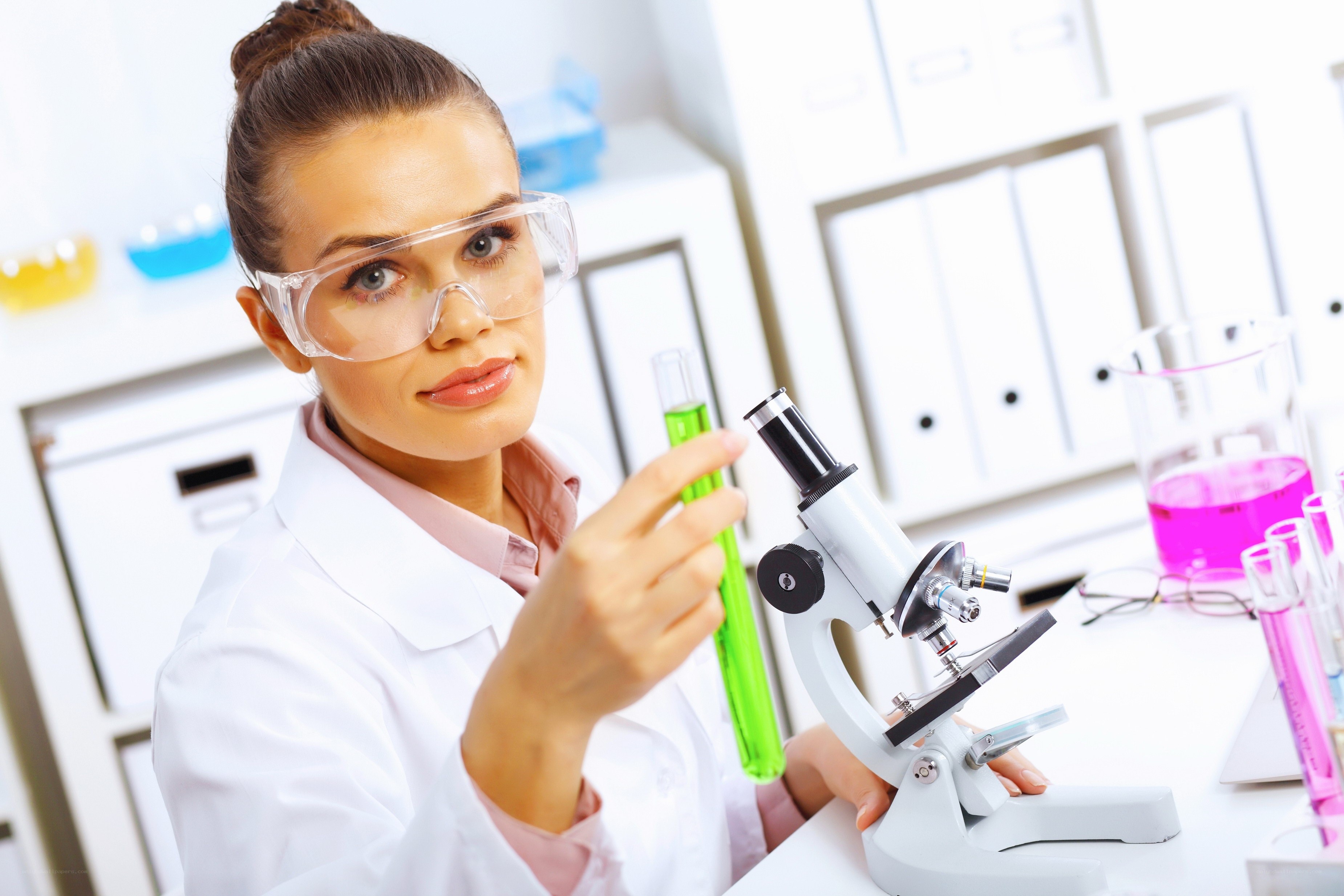 scientist in lab with microscope