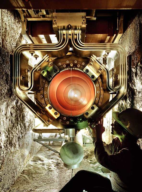 Scientist inspecting particle accelerator