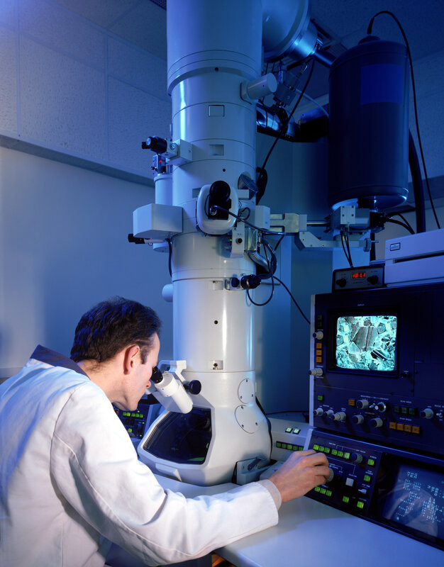 Scientist using electron microscope