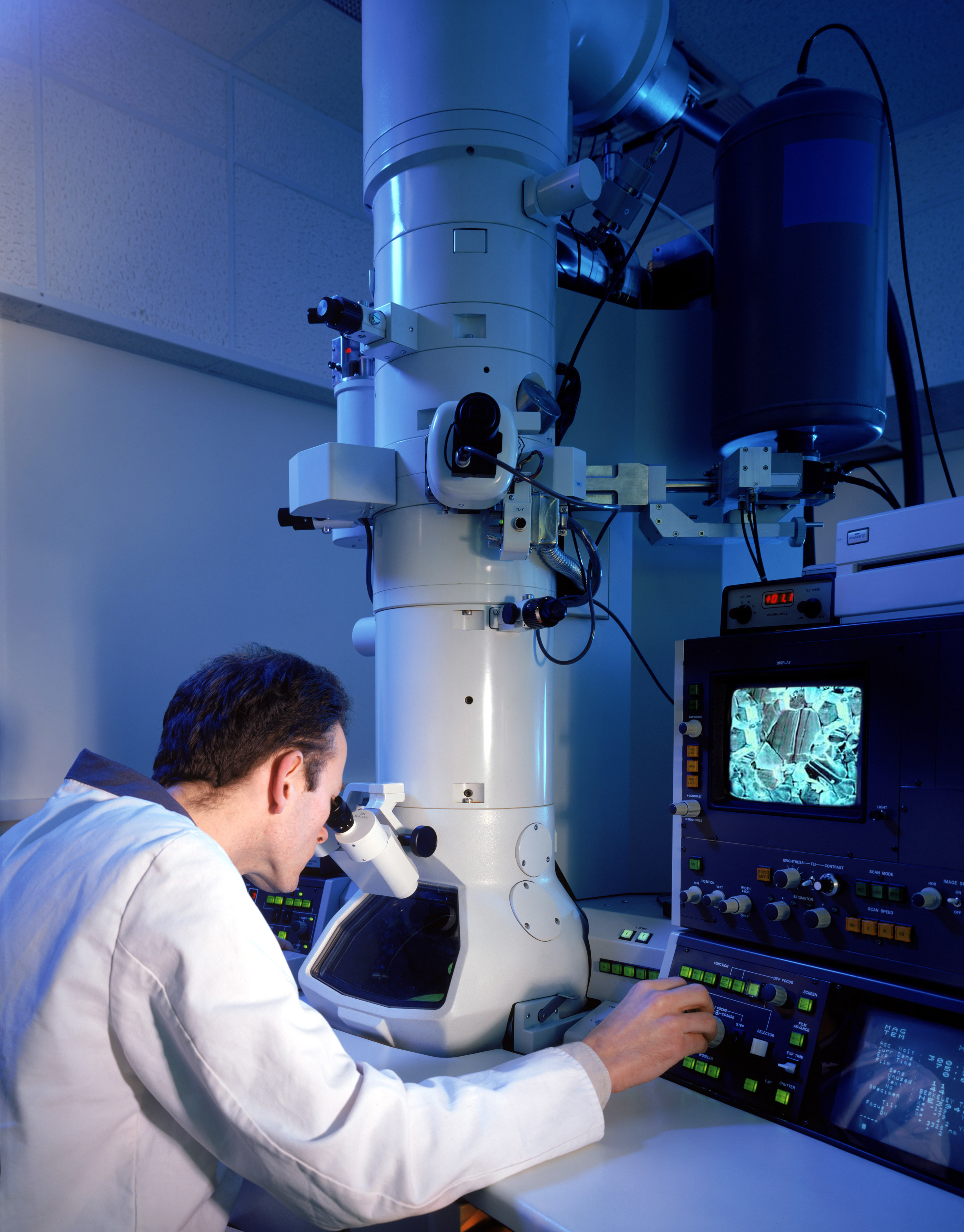 Scientist using electron microscope