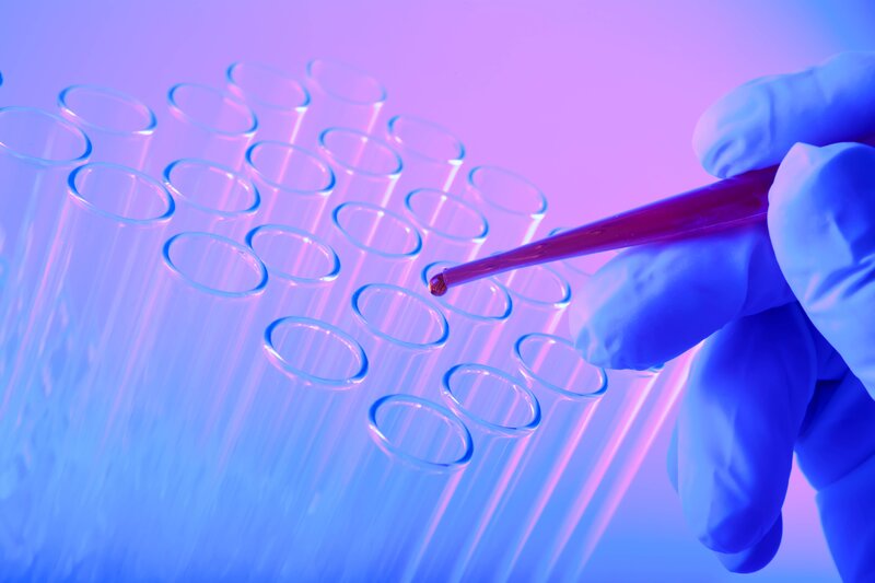 Scientist using pipette in lab