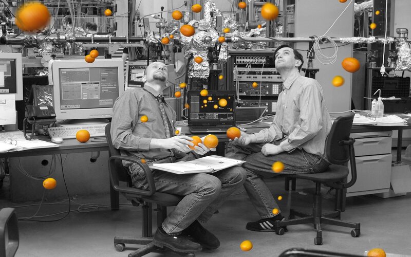 Scientists in a lab with floating oranges