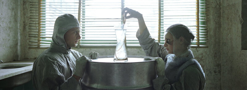 scientists in lab with flask