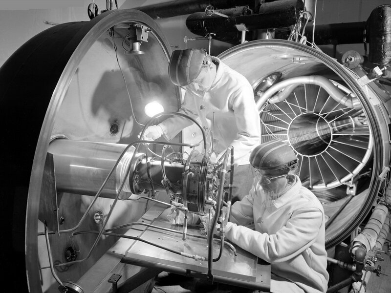 Scientists working on a large machine