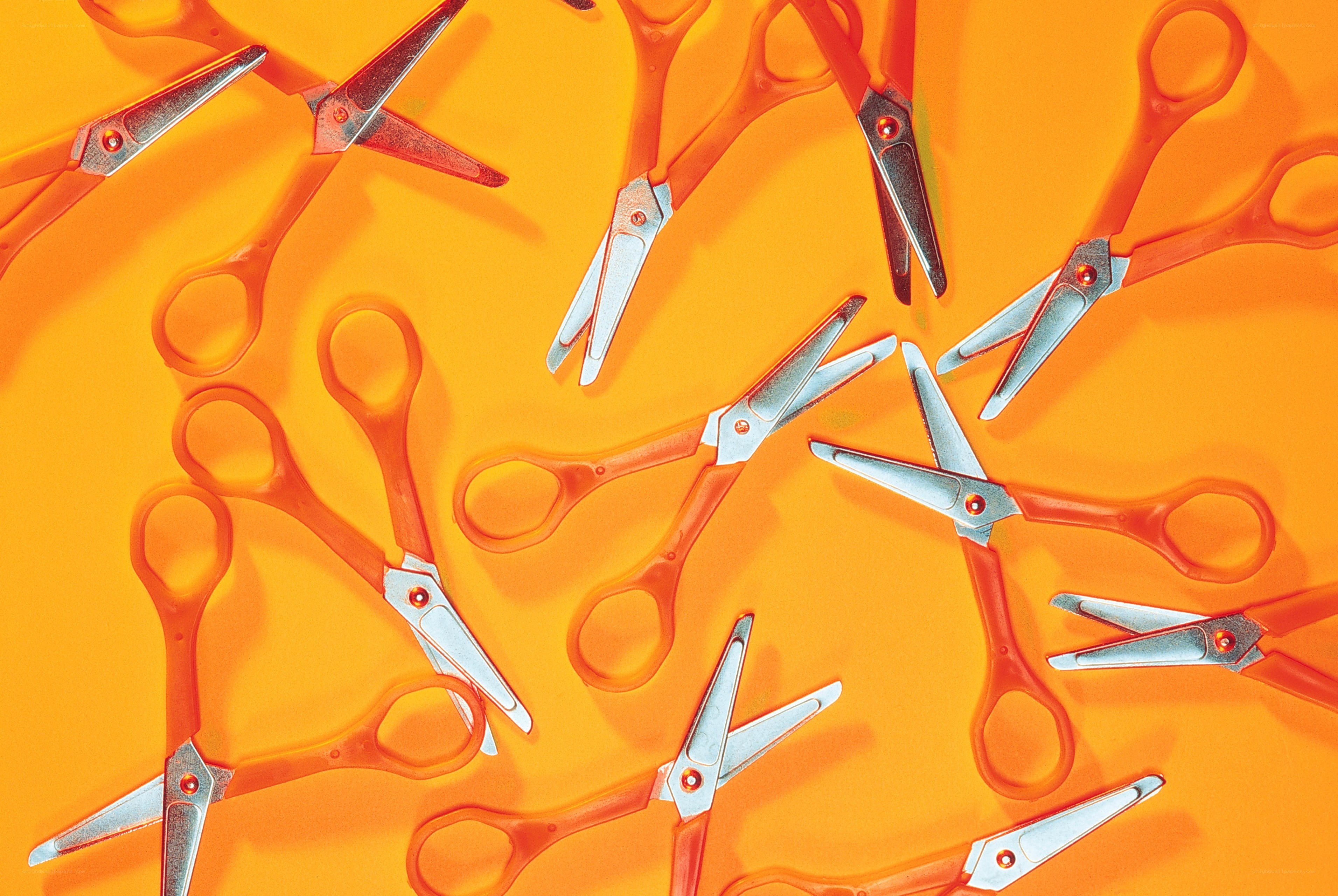 Scissors on orange background