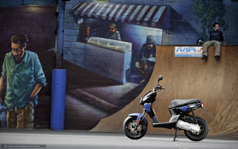 Scooter in front of graffiti wall
