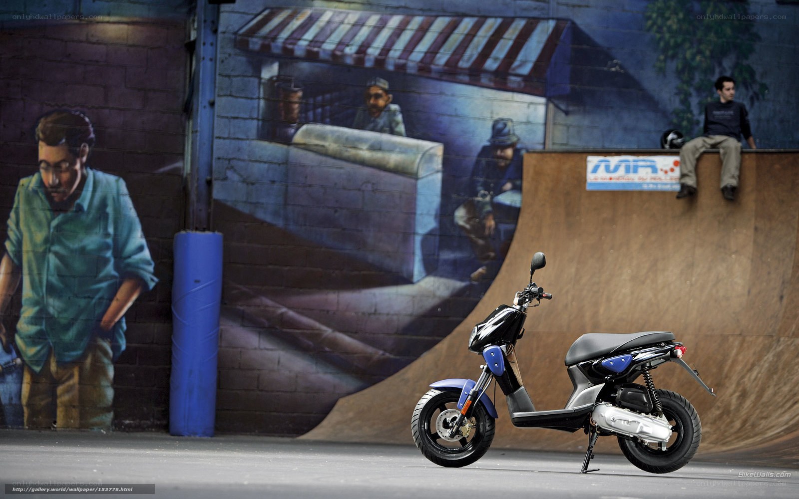 Scooter in front of graffiti wall