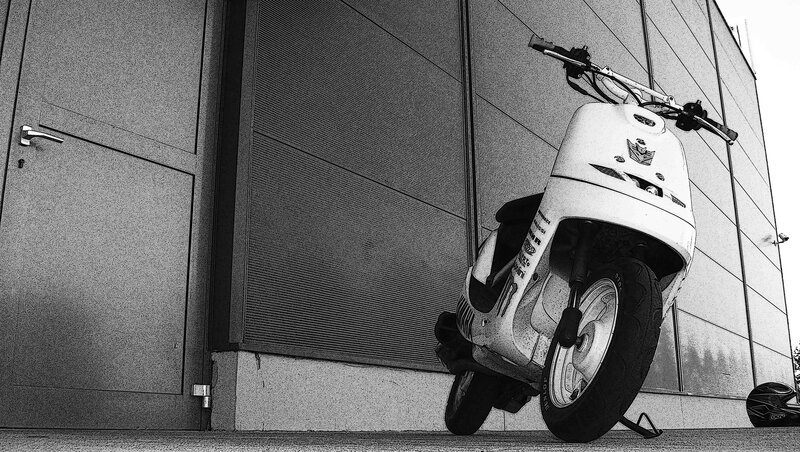scooter parked by building
