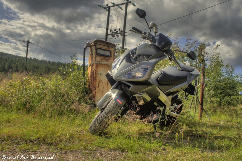 Scooter parked by old gas pump