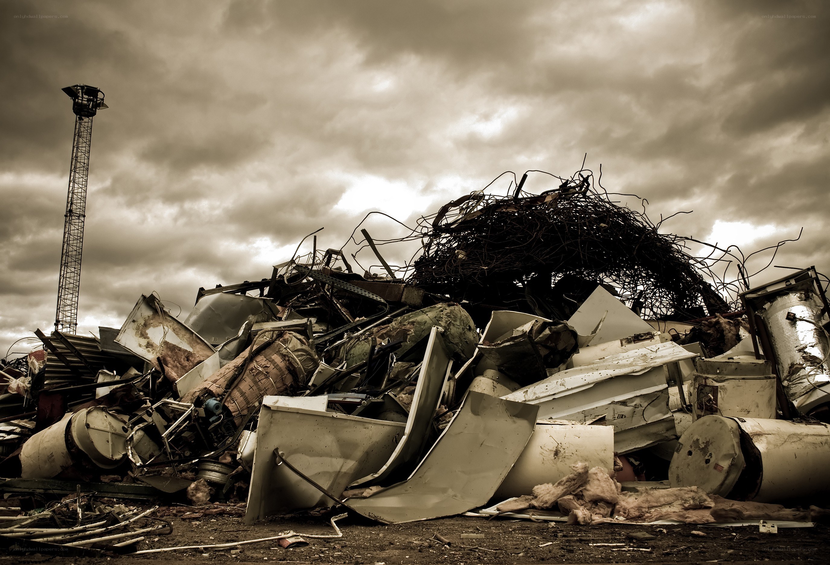 Scrap metal pile under stormy sky