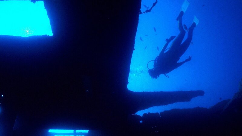 scuba diver exploring shipwreck