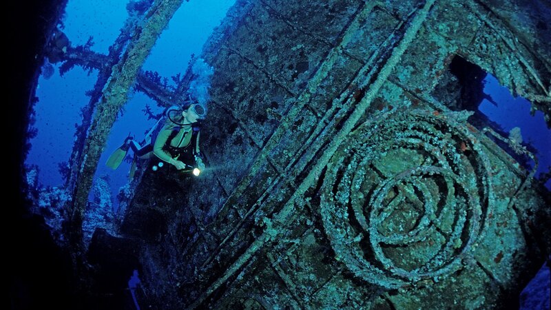 Scuba Diver Exploring Shipwreck — Blue, Dramatic