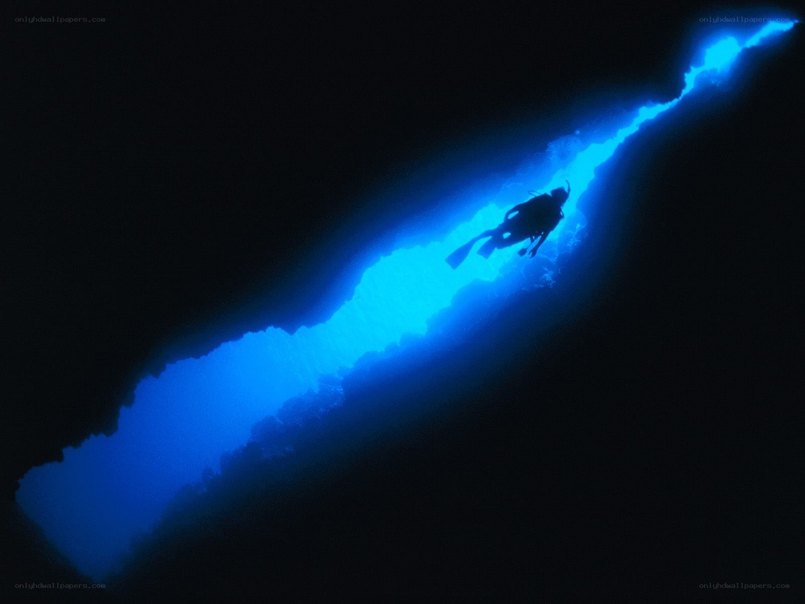 scuba diver in blue cave