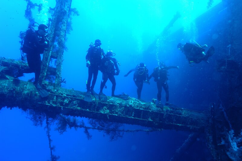 Scuba divers exploring shipwreck