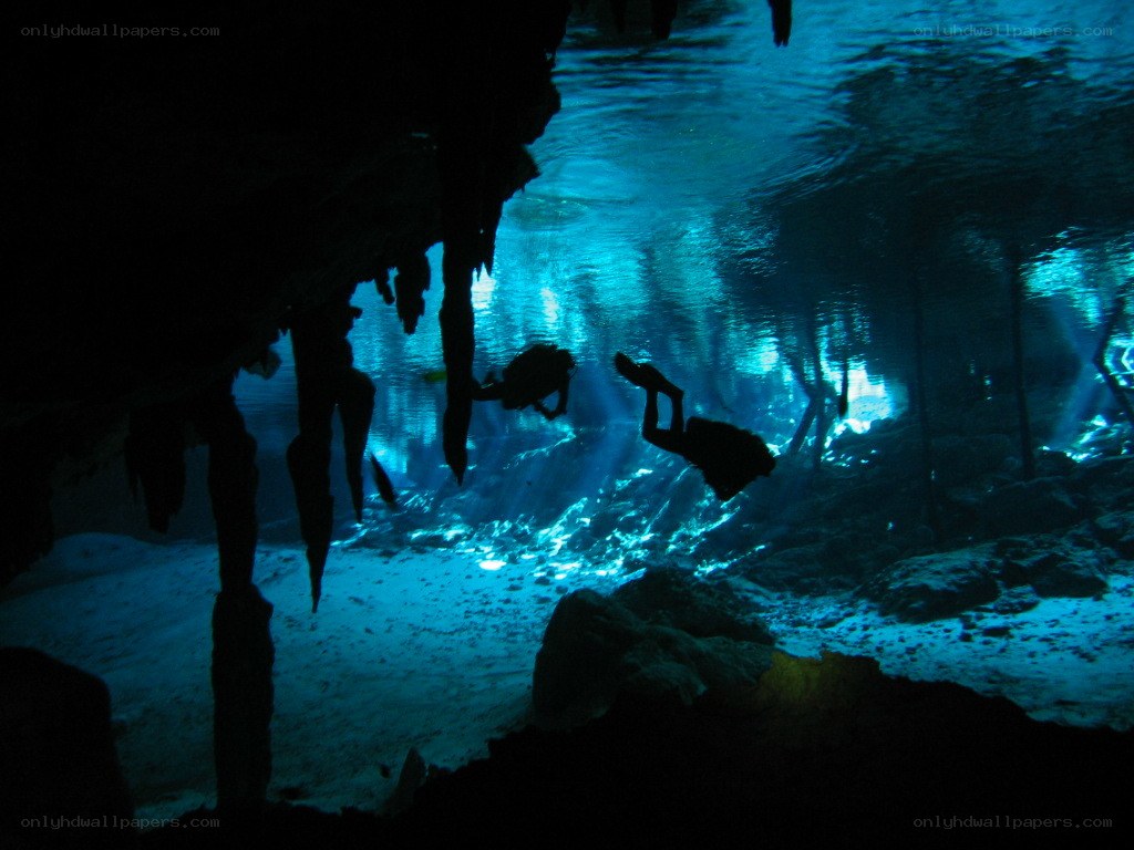 Scuba divers in underwater cave