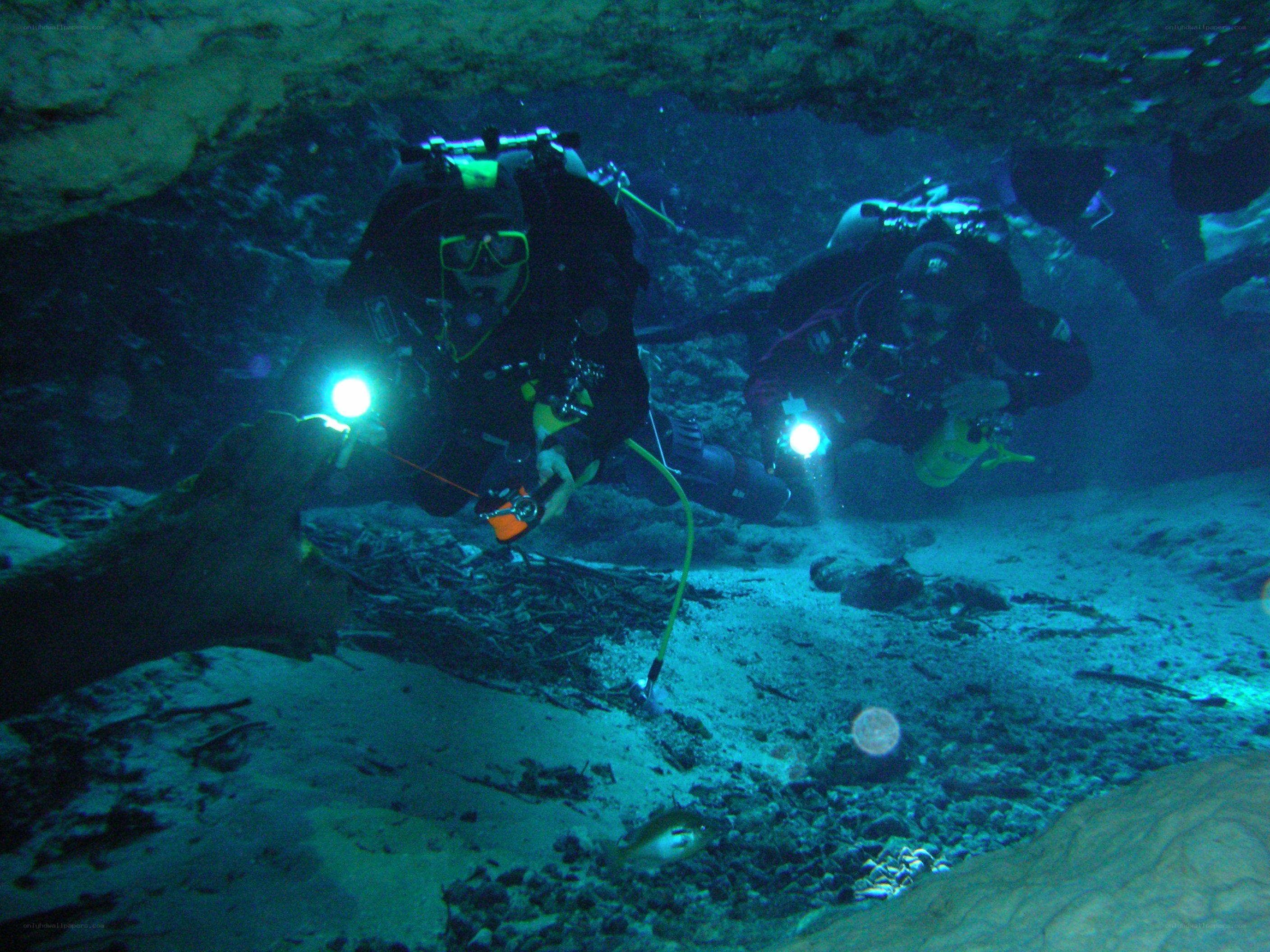 Scuba divers in underwater cave