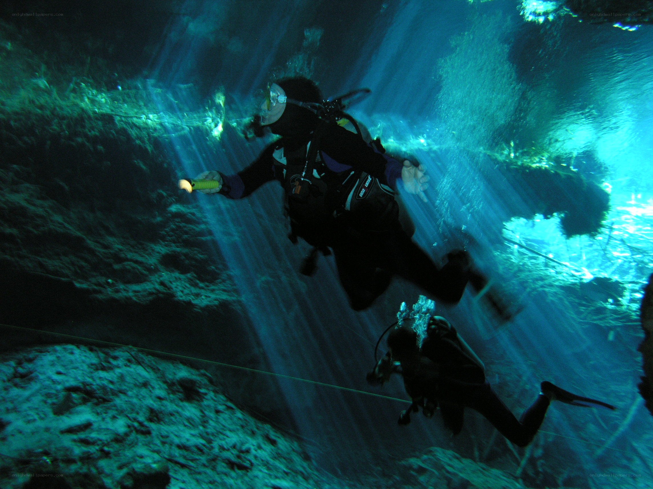 Scuba divers in underwater cave