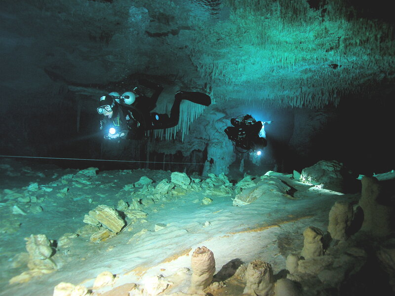 Scuba divers in underwater cave