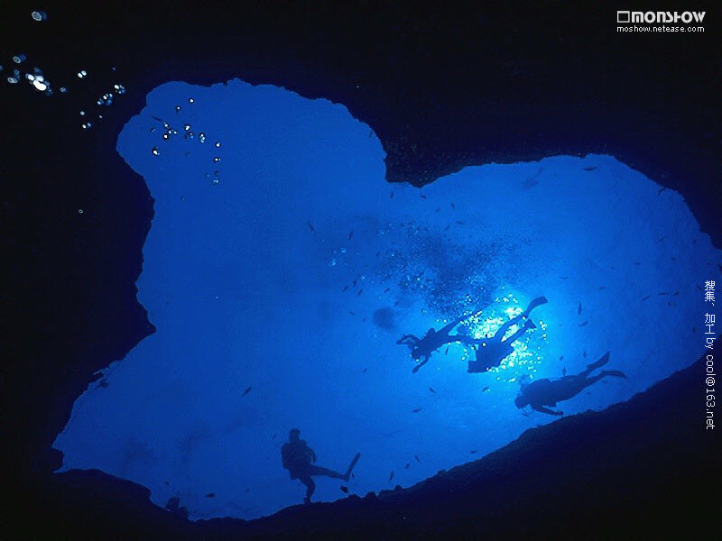 Scuba divers in underwater cave