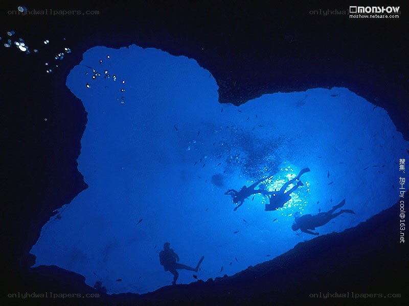 Scuba divers in underwater cave