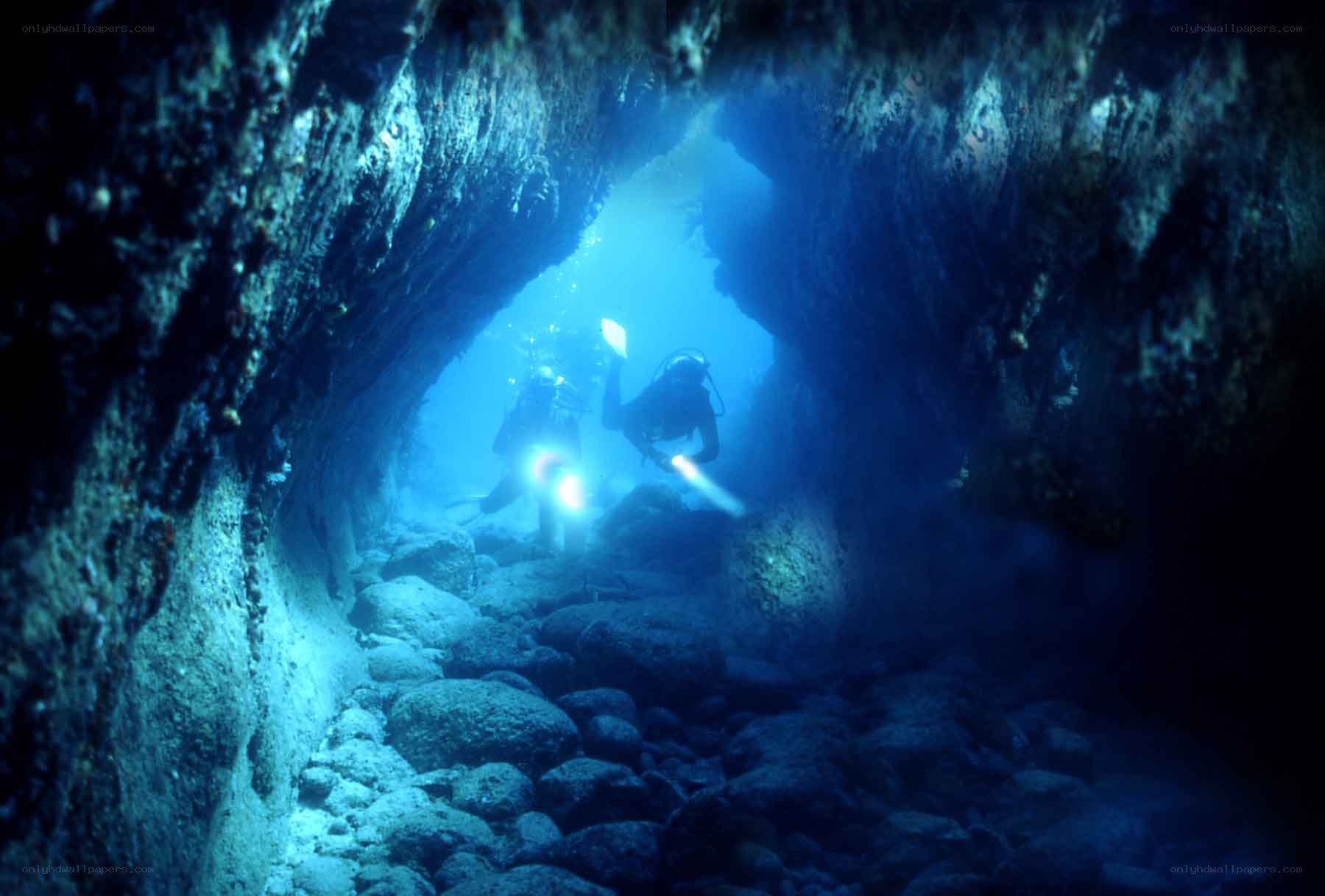 Scuba divers in underwater cave
