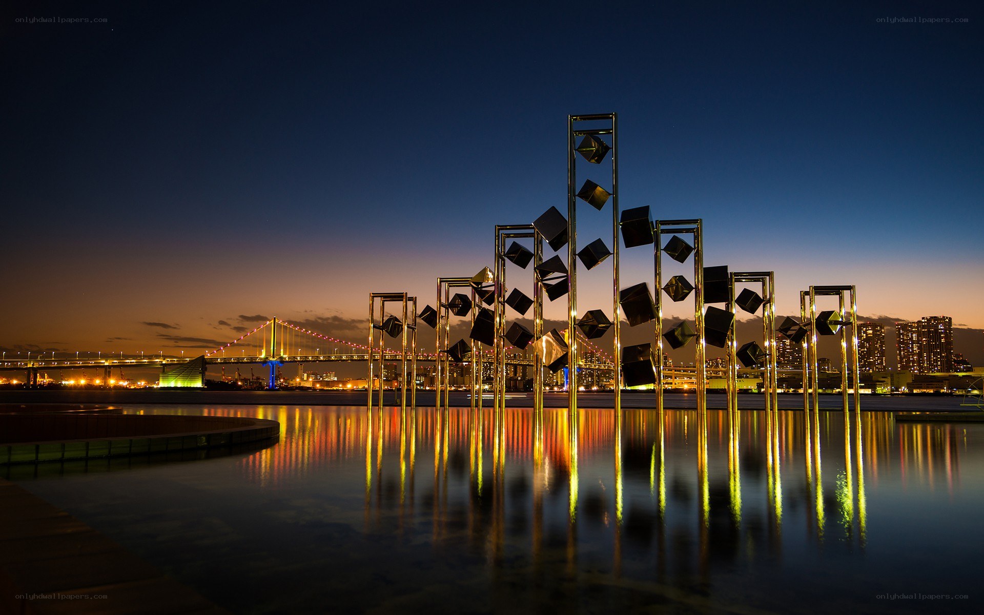 sculpture at dusk with bridge